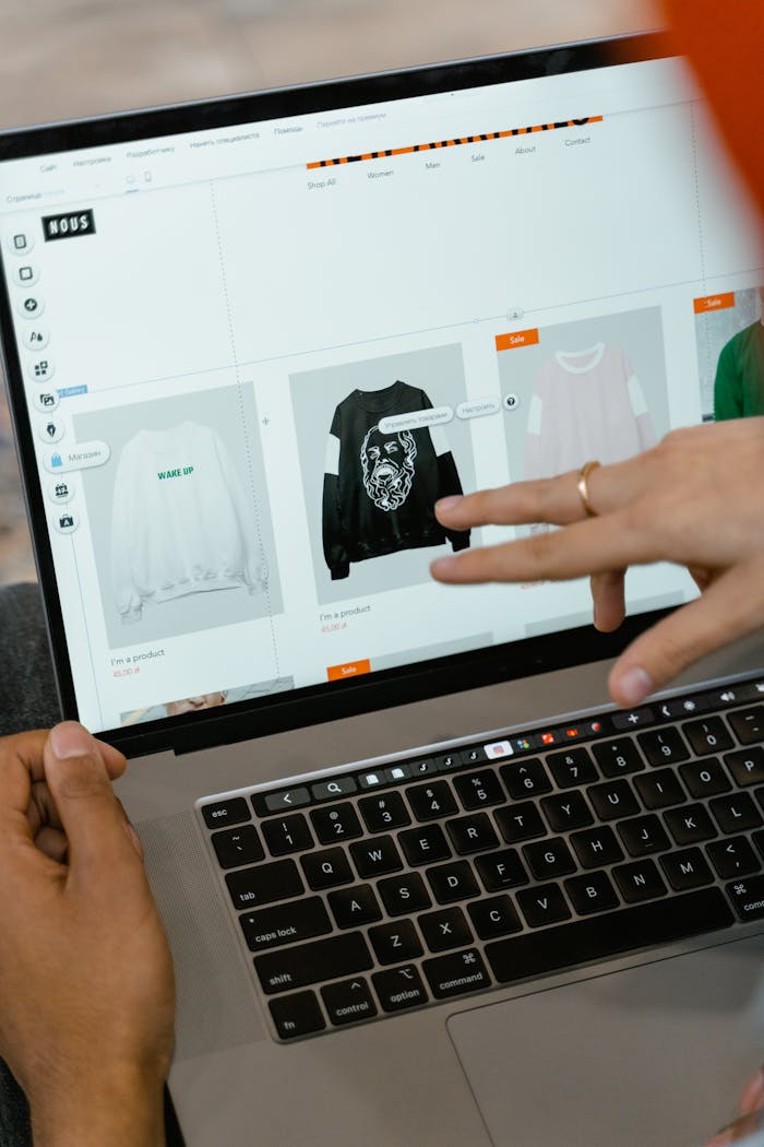 home-img Close-up of hands interacting with a shopping website on a laptop screen indoors.